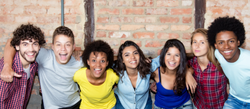 A group of seven people hugging together.